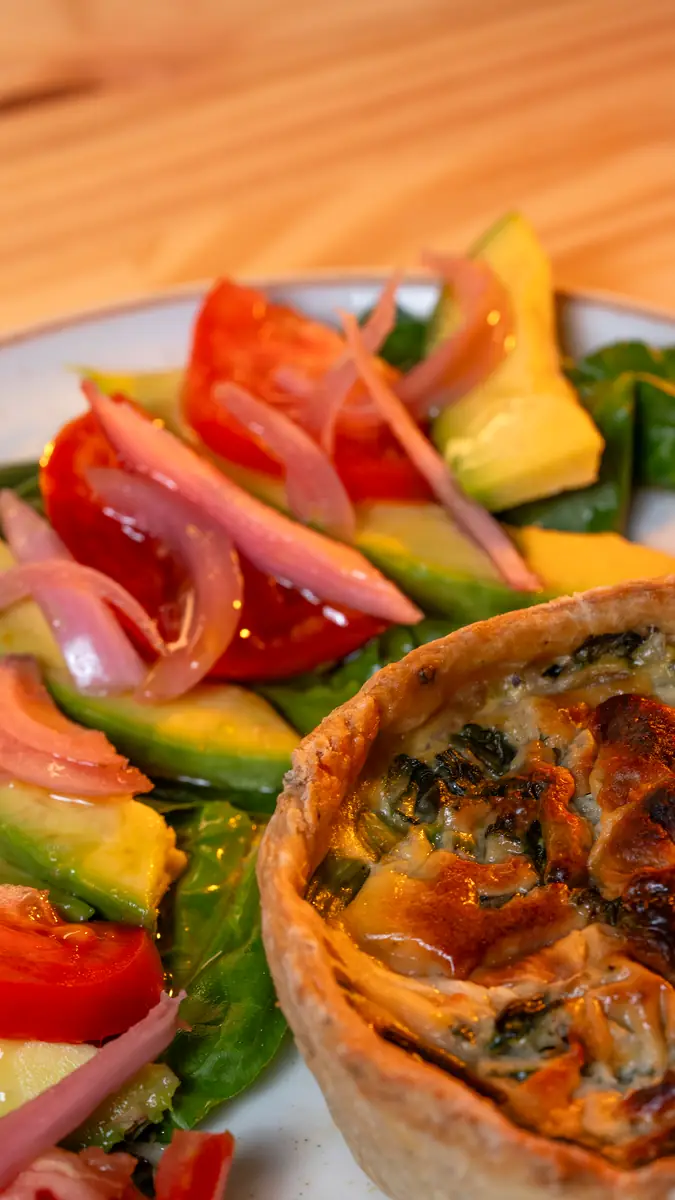 Quiche with avocado and tomato salad