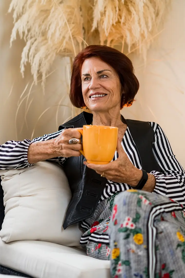 Woman smiling with a cup of coffee