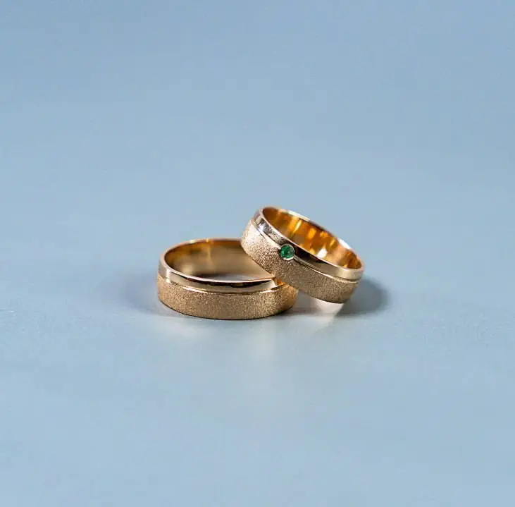 Pair of gold rings with an emerald