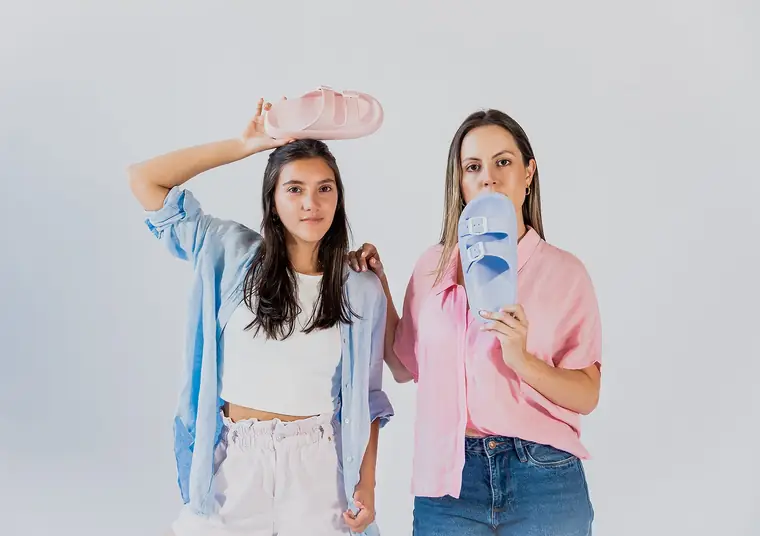 Two models posing in colorful sandals